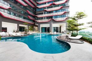 a swimming pool in front of a building at Minimalist Home 15mins to KLCC & Bkt Bintang in Kuala Lumpur