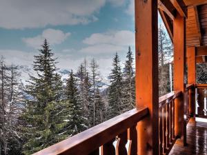 a balcony of a cabin with a view of the mountains at Chalet Chamois in Landry