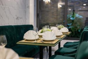 a table topped with plates filled with food at Amorita Boutique Hotel Hanoi in Hanoi