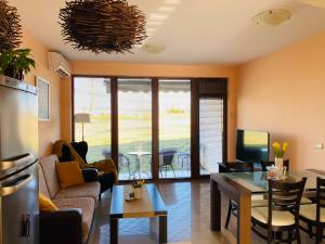 a living room with a couch and a table at Sunrise Lighthouse Golf Private Villa in Balchik