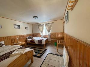 a small room with two beds and a window at Panorama Lodge and Restaurant in Nāmche Bāzār