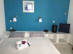 a blue room with a bed with flowers on it at Villa Irenes Dream - For dreamy holidays in Mikri Vigla