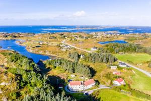 an aerial view of a house on a hill next to a river at Vollvaagen Apartments Smøla, boat included in Smøla