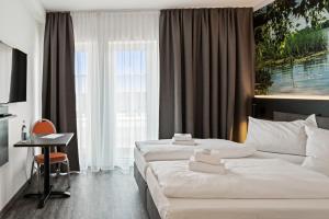 Postel nebo postele na pokoji v ubytování Hotel Amper