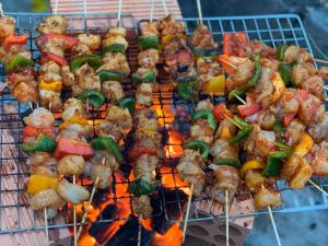 a bunch of food cooking on a grill at Gia An Hung Guest House in Mui Ne