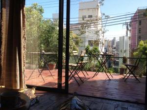 a balcony with a view of a table and chairs at Hostel Yume-Nomad Kobe in Kobe