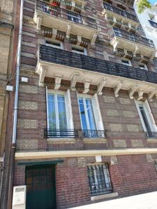 a brick building with windows and a door at JungLH by Beds76 in Le Havre