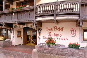a building with a balcony on the side of it at Hotel Rubino Deluxe in Campitello di Fassa