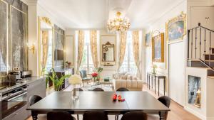 a living room with a table and chairs at Royale 3 Bedroom, 2 Bathroom Apartment With AC - Louvre in Paris