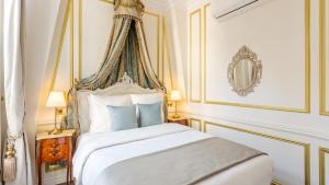 a bedroom with a white bed with a canopy at Royale 3 Bedroom, 2 Bathroom Apartment With AC - Louvre in Paris