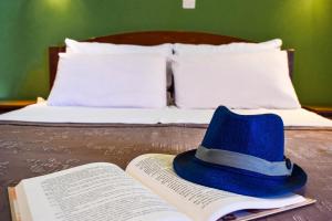 a blue hat sitting on top of an open book at Panorama Hotel in Falasarna