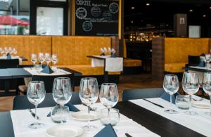 a table with wine glasses on it in a restaurant at Hotel Royal Astrid in Ostend