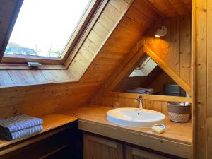 a bathroom with a sink in a wooden cabin at Le Huic maison de marin lambrissée in Bénodet +18 photos