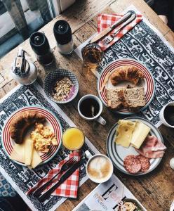 a wooden table with plates of food on it at Hamilton Lodge & Spa in Belalp