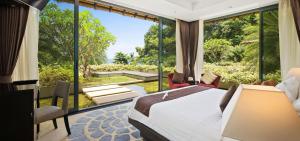 a bedroom with a bed and a large window at Sangsuri Villa 3 in Choeng Mon Beach +26 photos