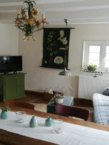 a living room with a table and a couch at Ferienwohnung Am Schloßberg in Solingen