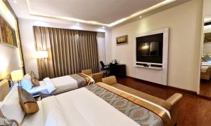 Postel nebo postele na pokoji v ubytování Bravura Gold Resort
