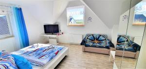 a bedroom with a bed and a desk and a chair at Fewo Traum in Neppermin +37 photos