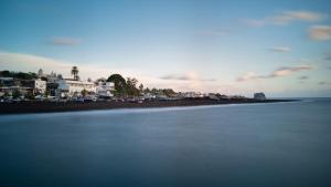 a body of water with cars parked on a beach at Hotel Ossidiana Stromboli Center in Stromboli