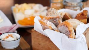 a bunch of donuts in a wooden basket on a table at Herdade do Ananás in Ponta Delgada
