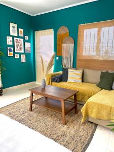 a living room with a couch and a coffee table at Bohem Apartment near Athens Airport in Spata