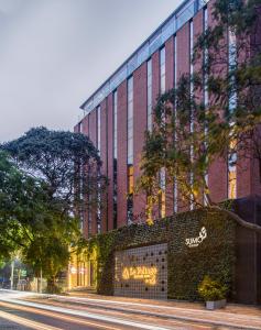 a building with a sign on the side of it at Le Foliage by TGI in Bangalore