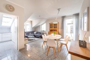 a kitchen and living room with a table and chairs at Appartment Strandduene in Binz