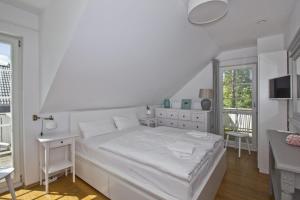 Postel nebo postele na pokoji v ubytování Ferienhaus Frigga Haus - Terrasse, Garten, Meerblick