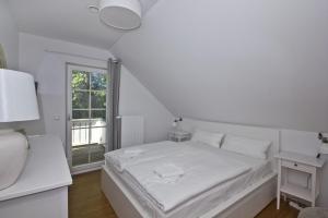 Postel nebo postele na pokoji v ubytování Ferienhaus Frigga Haus - Terrasse, Garten, Meerblick