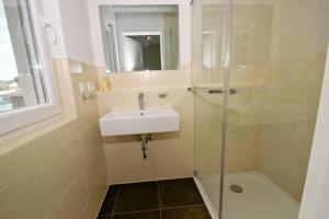 a bathroom with a sink and a shower at hafennahe Penthousewohnung mit Meerblick - Hafenresidenz Lauterbach FeWo 2-7 in Lauterbach +11 photos