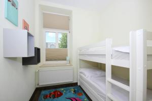 ein kleines Zimmer mit einem Etagenbett und einem Fenster in der Unterkunft Ferienwohnung mit eigener Sauna in zentraler Lage - Kurhaus Nordstrand FeWo 32 in Göhren