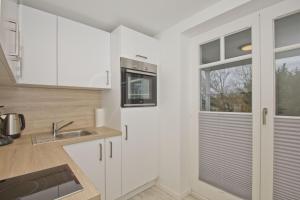 Kuchyň nebo kuchyňský kout v ubytování moderne Ferienwohnung mit Sauna und Terrasse - Ferienresidenz Zwei Bodden 112