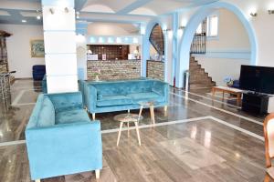 a lobby with blue furniture and a staircase at Lido Corfu Sun Hotel 4 Stars All-inclusive in Benitses