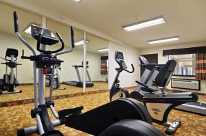 a gym with several treadmills and cardio machines at Days Inn by Wyndham Oklahoma City/Moore in Oklahoma City