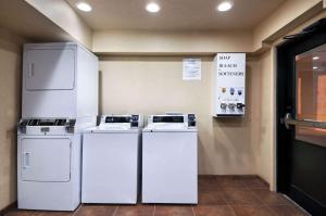 two white refrigerators sitting next to each other in a room at Days Inn by Wyndham Oklahoma City/Moore in Oklahoma City