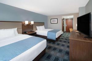 a hotel room with two beds and a flat screen tv at Holiday Inn Express & Suites - Mobile - I-65, an IHG Hotel in Mobile