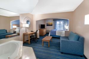 a hotel room with a bed and a bath tub at Days Inn by Wyndham Panama City in Panama City