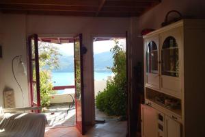an open door to a room with a view of the ocean at The Red-Fish House in Astypalaia