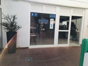 a sliding glass door of a store with a sign on it at Apartamentos Europa, Playa del Inglés in Playa del Ingles