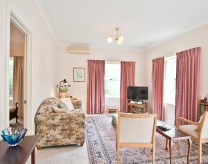 a living room with a couch and a chair at Encounter Hideaway Cottages in Encounter Bay