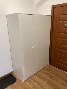 a white cabinet next to a wooden door at Mega widok 3 in Szklarska Poręba