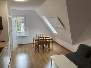 a small living room with a table and chairs at Mega widok 3 in Szklarska Poręba
