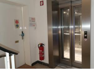 a fire hydrant is next to a door in a building at MAC City Hostel in Hamburg