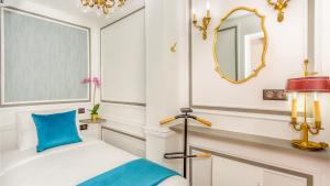 a bedroom with a bed and a mirror at Luxury 3 bedroom Loft in Heritage Building - LE MARAIS in Paris