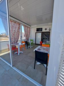 a living room with a table and chairs at B&B La Casa di Pino in Lampedusa