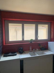 a kitchen with a sink and a window at L’ÉMERAUDE 4 in Chalons en Champagne