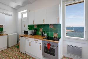 a kitchen with a view of the ocean at Cabanon de Malmousque in Marseille