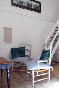 a living room with two chairs and a staircase at Villa COLIBRI in Lorgues