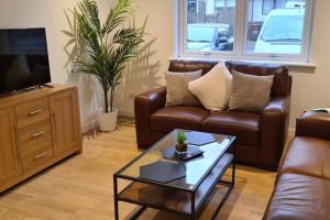 a living room with a couch and a coffee table at Craiglynn Holiday Apartment Loch Lomond in Balloch