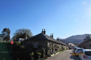 a row of houses on a street in a village at Craiglynn Holiday Apartment Loch Lomond in Balloch